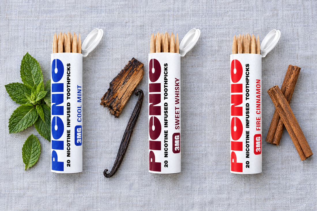 Picnic Cool Mint, Sweet Whiskey and Fire Cinnamon tubes laid out with mint leaves, oak and cinnamon sticks